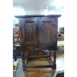 A small carved oak two door cupboard