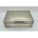 A silver cigarette box, with inscription, width 12.5cm