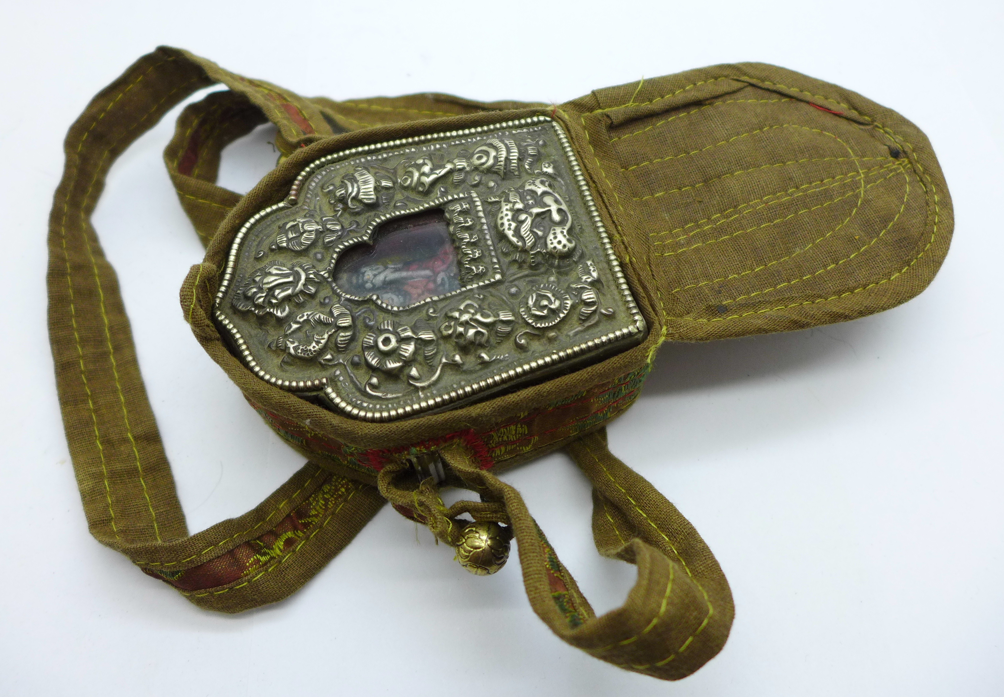 A Tibetan Ghau prayer box in copper and white metal within a canvas and needlework pouch - Image 4 of 4