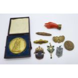 A carved hand brooch, three other brooches, a fob, a pendant marked 950MB, a/f, and three