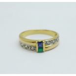 A yellow metal ring set with blue, green and white stones, control marks on the outside of the