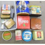 Two boxes of advertising tins and a small Nikon shop display metal plaque