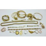 A collection of gold tone jewellery including a 9ct gold metal core bangle and a silver gilt locket