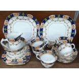 A six setting china tea service, five cups, six saucers, side plates, two cake plates, sugar and