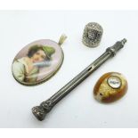 A silver mounted portrait pendant, a novelty compass mounted shell, a hallmarked silver thimble, a/