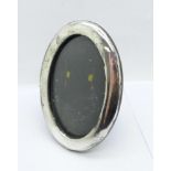 An oval silver photograph frame, Birmingham 1921, height 11.5cm