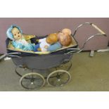 A Palitoy early hard plastic doll, circa 1930-1948, three other dolls and a Tri-ang doll's pram