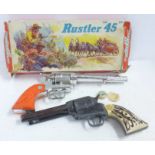 A Crescent Toys Rustler '45' six chamber repeater cap gun, boxed, and one other model pistol