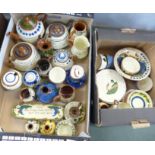Two boxes of Watcombe Torquay Motto Ware pottery, tea pots, vases, jugs, plates and bowls