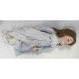 A French Limoges bisque head doll with deep violet sleep eyes, Limoges 9 identification mark,