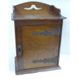 A circa 1900 wooden smokers cabinet