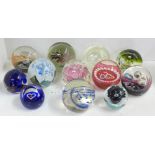 Twelve glass paperweights including Caithness, five with certificates