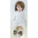 A French Jules Verlingue bisque head doll with brown open eyes, JV 6 identification mark, circa