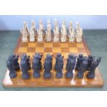 A resin chess set with Chinese figures and wooden board (complete)