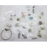 Twenty-five pairs of silver earrings