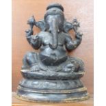 A carved wooden figure of a sitting Ganesh, 35cm