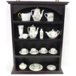 A miniature Wedgwood tea set, etc., and a display case