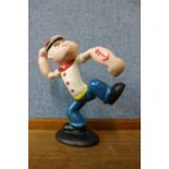 A small painted cast iron Popeye figure