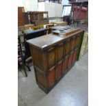 A carved oak and red leather panelled corner bar