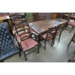 An oak draw-leaf refectory table and six chairs