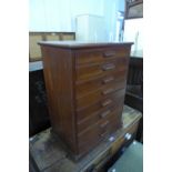 A stained pine table top eight drawer collectors cabinet