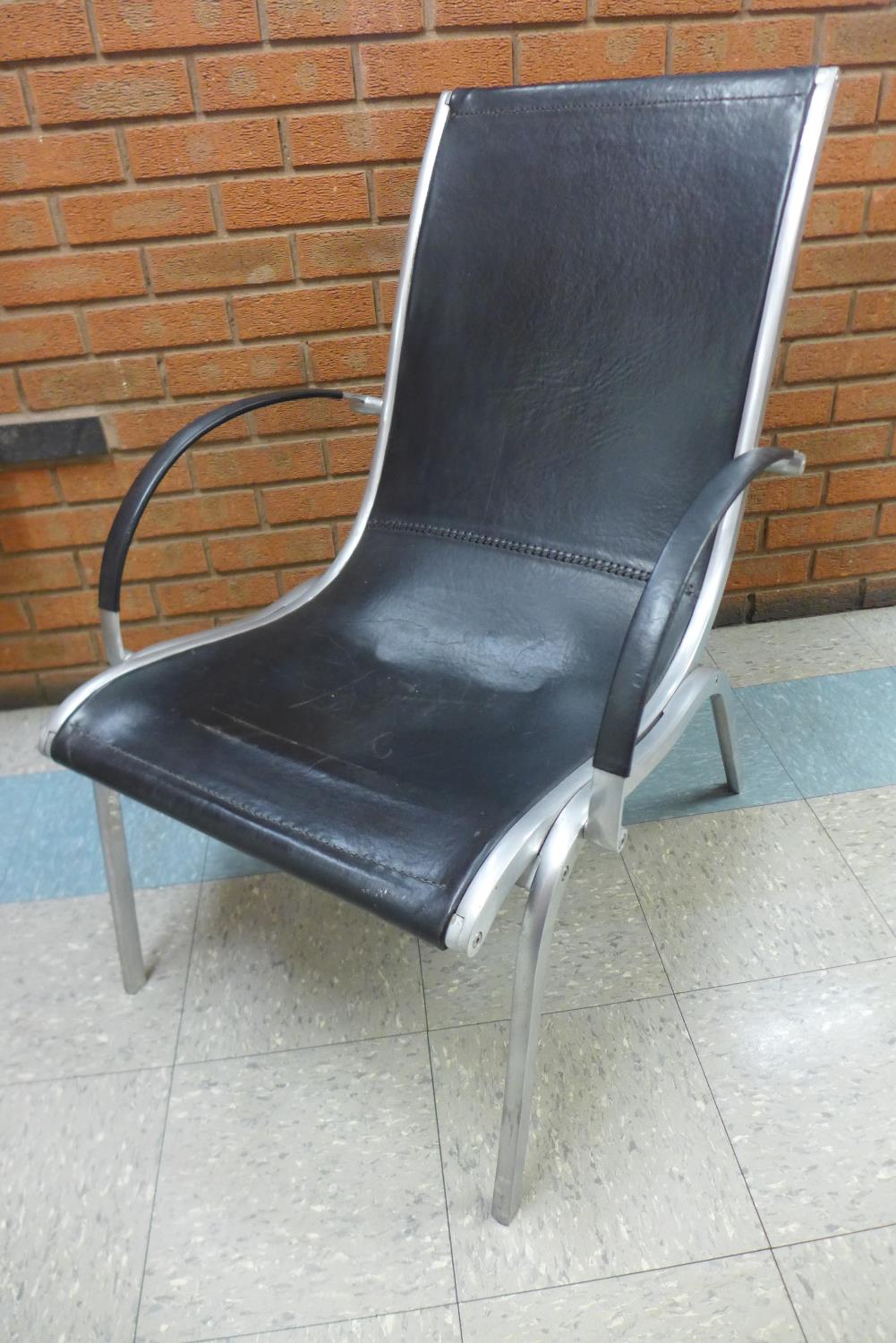 A chrome and black leather lounger chair