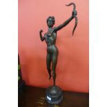 A bronze figure of Diana the Huntress, on black marble socle