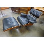 A Charles & Ray Eames style black leather, walnut and chrome revolving lounge chair and stool