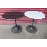 A pair of cast iron and marble topped pub tables