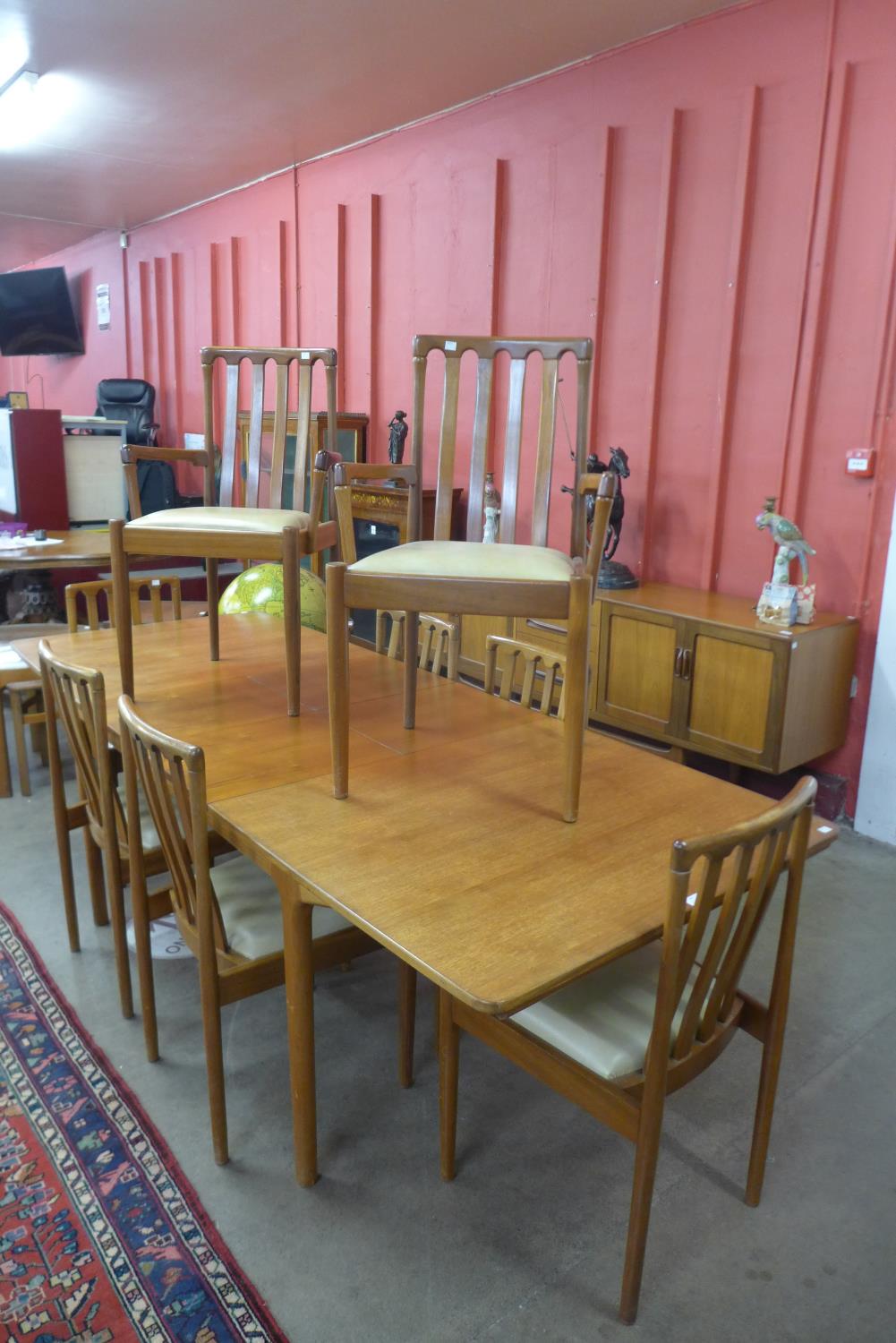 A McIntosh teak double leaf extending dining table and eight chairs