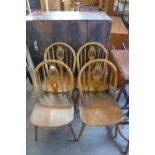 A set of four Ercol Golden Dawn elm and beech fleur de lys chairs