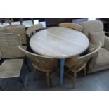 A pine circular kitchen table and four beech chairs