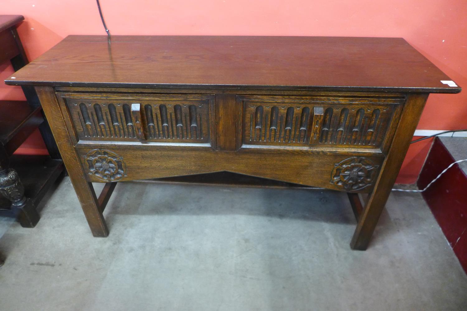 A 17th Century style carved oak two drawer dresser