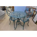 A green cast alloy garden table and two chairs