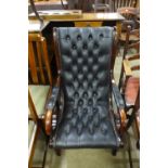 A mahogany and black leather open armchair