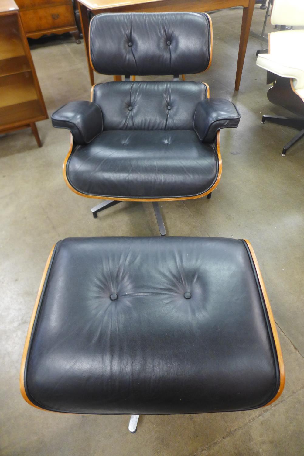 A Charles & Ray Eames style black leather, walnut and chrome revolving lounge chair and stool - Image 2 of 3