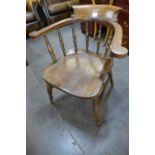 A Victorian elm and beech smokers bow chair