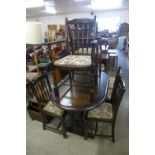 An oak extending dining table, six chairs and a corner cabinet