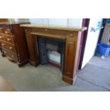 A cast iron fire surround with beech chimney-piece