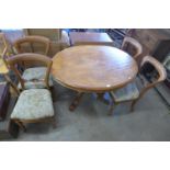 A Victorian walnut oval tilt-top breakfast table and a set of four mahogany balloon back chairs