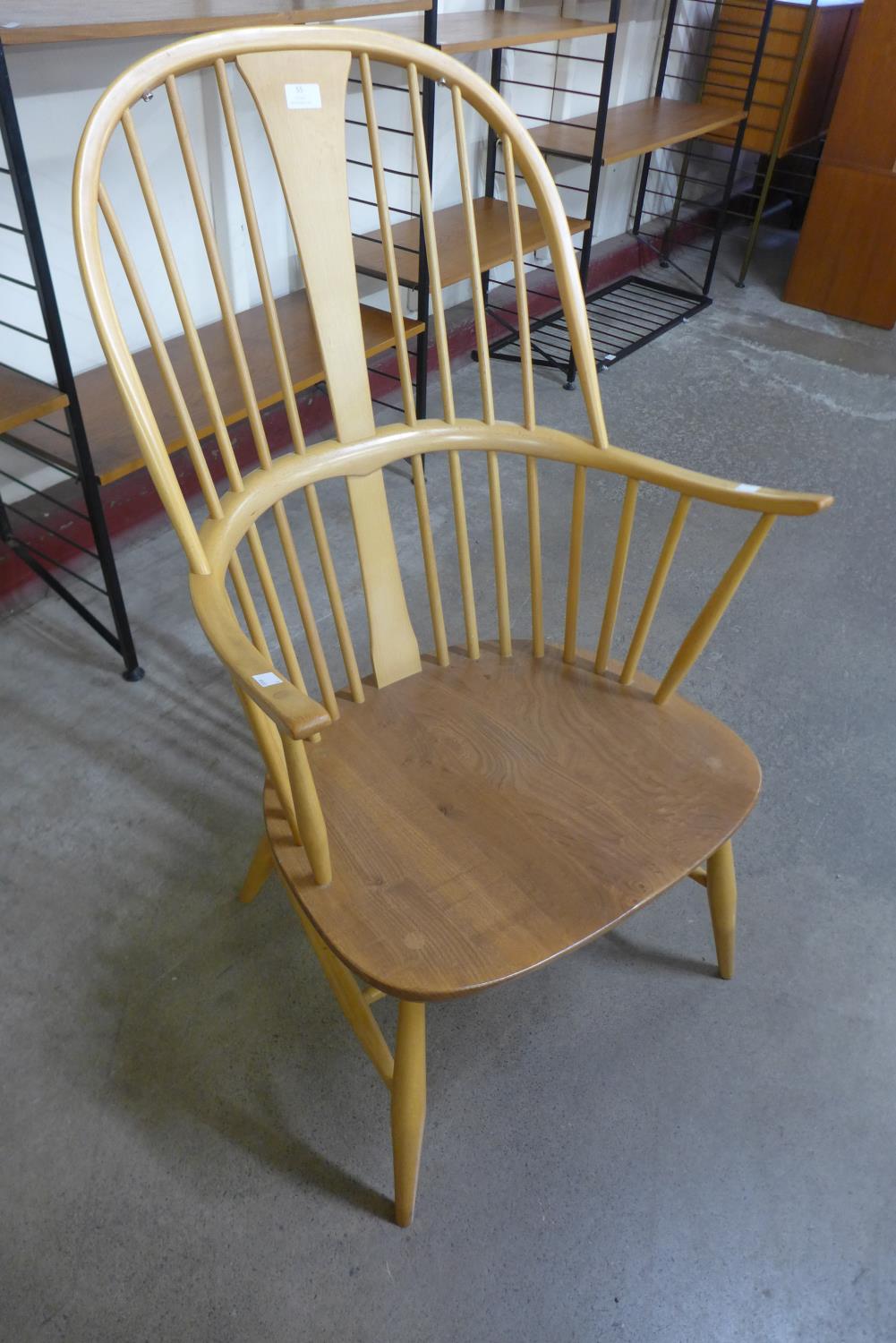 An Ercol blonde elm and beech armchair