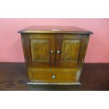 A mahogany table top cabinet