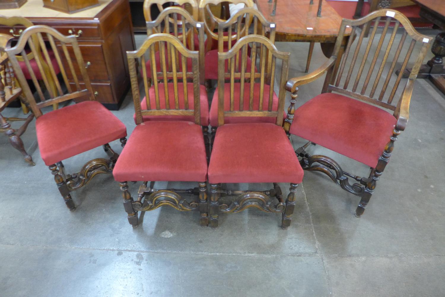 A set of six Jacobean Revival carved oak chairs