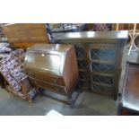 An oak two door bookcase and a bureau