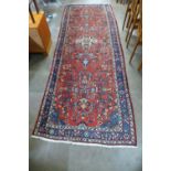 An eastern geometric patterned red ground runner rug