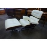 A Charles & Ray Eames style cream leather, rosewood effect and chrome revolving lounge chair and