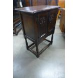 A small carved oak two door cupboard