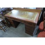 A mahogany and leather topped pedestal desk