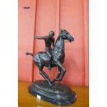 A large bronze figure of a polo player on horse, on black marble plinth