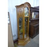 A German carved oak triple weight longcase clock, with brass moonphase rolling dial